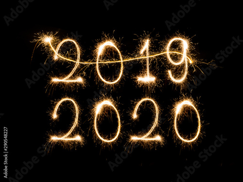 Happy New Year 2020. Creative text Happy New Year 2020 written sparkling sparklers isolated on black background for design，Merry Christmas