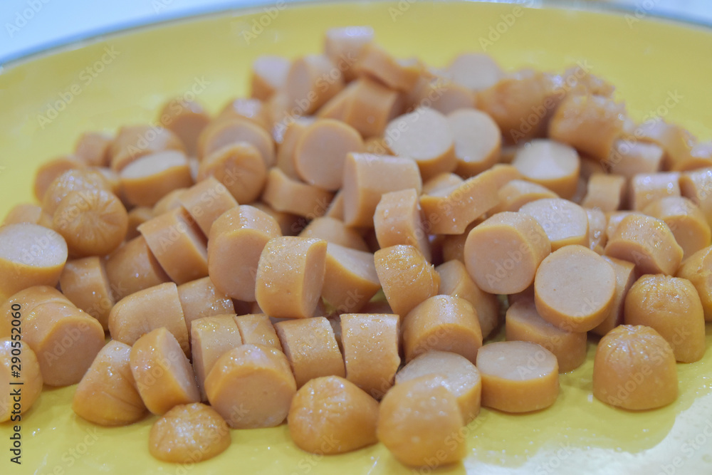 Tasty traditional slices of pork sausage on plate in restaurant.