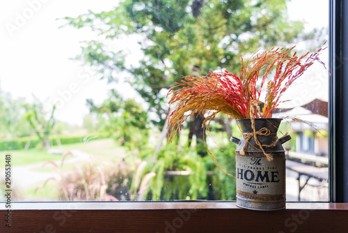 The colorful rice decorated in stainless jar placed next to the window photo