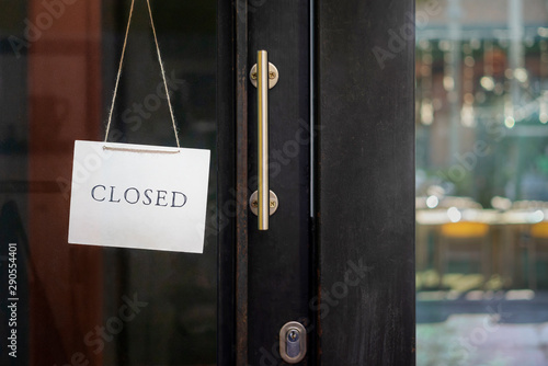 closed sign hanging outside a restaurant, store, office or other photo