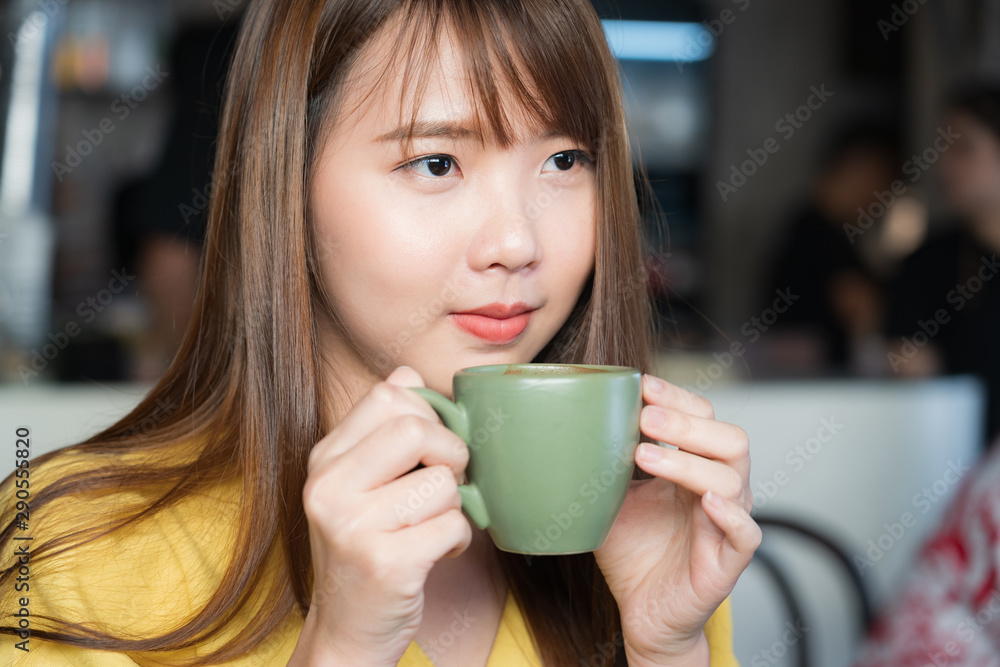Pretty female drinking coffee in cozy cafe during lunch Pretty female drinking coffee in cozy cafe during lunch
