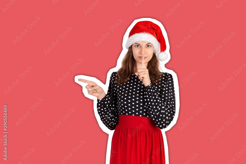 Young woman in dress pointing something with smile. emotional girl in santa claus christmas hat Magazine collage style with trendy color background. holiday concept Young woman in dress pointing something with smile. emotional girl in santa claus christmas hat Magazine collage style with trendy color background. holiday concept
