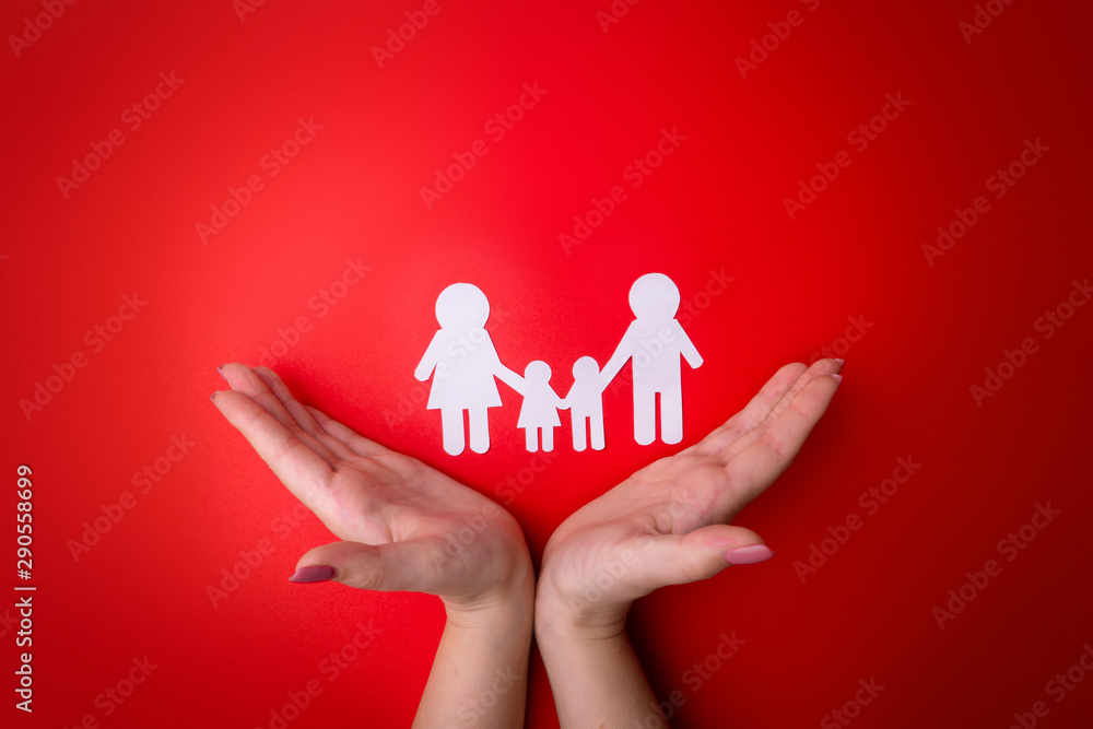 Female tender hands with a family symbol cut out of white paper. Protecting the rights of people and sexual minorities. Love for the children of the world on earth, a clean ecology. View from above. Female tender hands with a family symbol cut out of white paper. Protecting the rights of people and sexual minorities. Love for the children of the world on earth, a clean ecology. View from above.