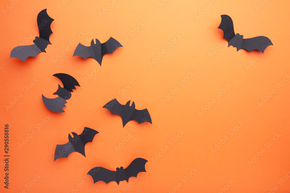 Halloween paper bats on orange background. Halloween concept Halloween paper bats on orange background. Halloween concept
