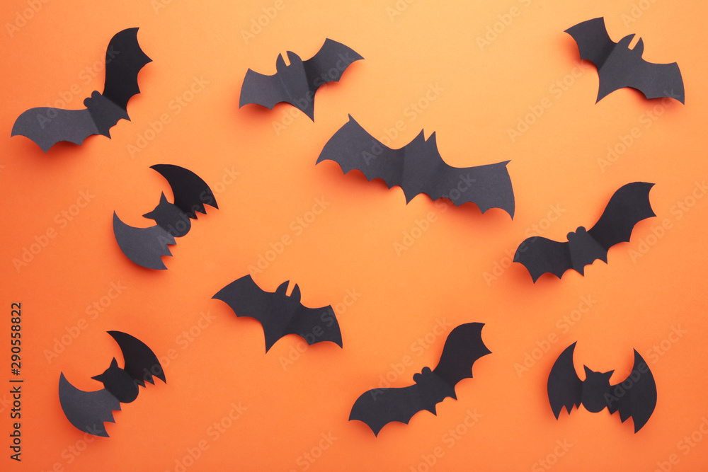 Fototapeta premium Halloween paper bats on orange background. Halloween concept