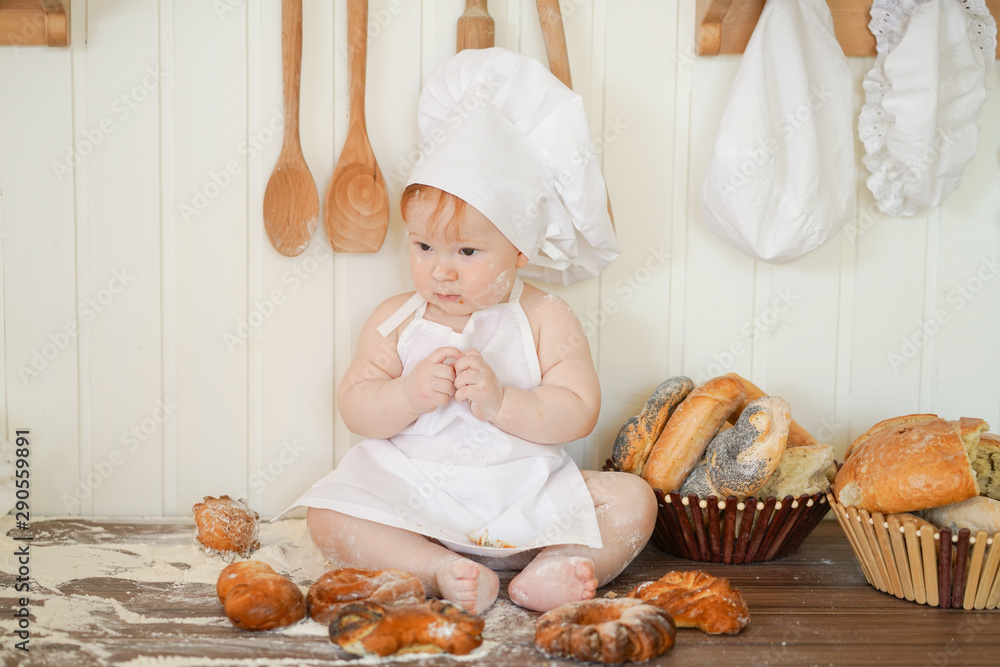 little baker child in chef hat at kitchen table alone little baker child in chef hat at kitchen table alone