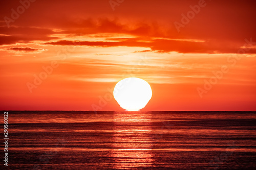 Beautiful red and orange sunset over the sea. The sun goes down over the sea.