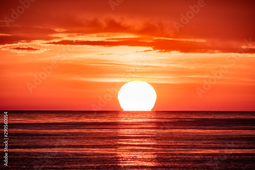 Fototapeta Naklejka Na Ścianę i Meble -  Beautiful red and orange sunset over the sea. The sun goes down over the sea.