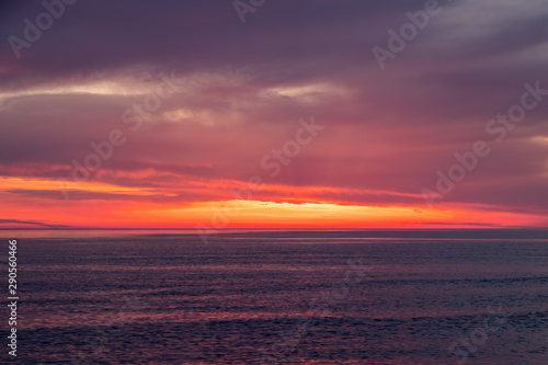 Beautiful red and orange sunset over the sea. © Dmitrii Potashkin