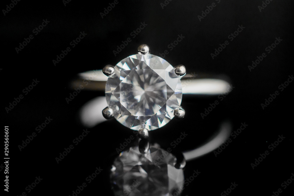 Close up diamond ring jewelry with reflection on black background