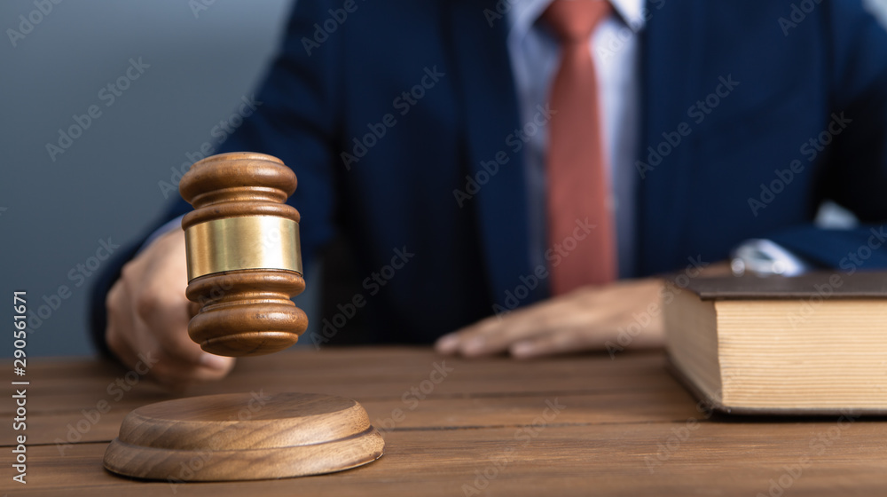 The concept of justice and law. judge in the courtroom with a hammer The concept of justice and law. judge in the courtroom with a hammer