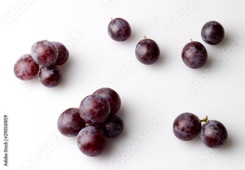 Study of red grapes with bloom against white