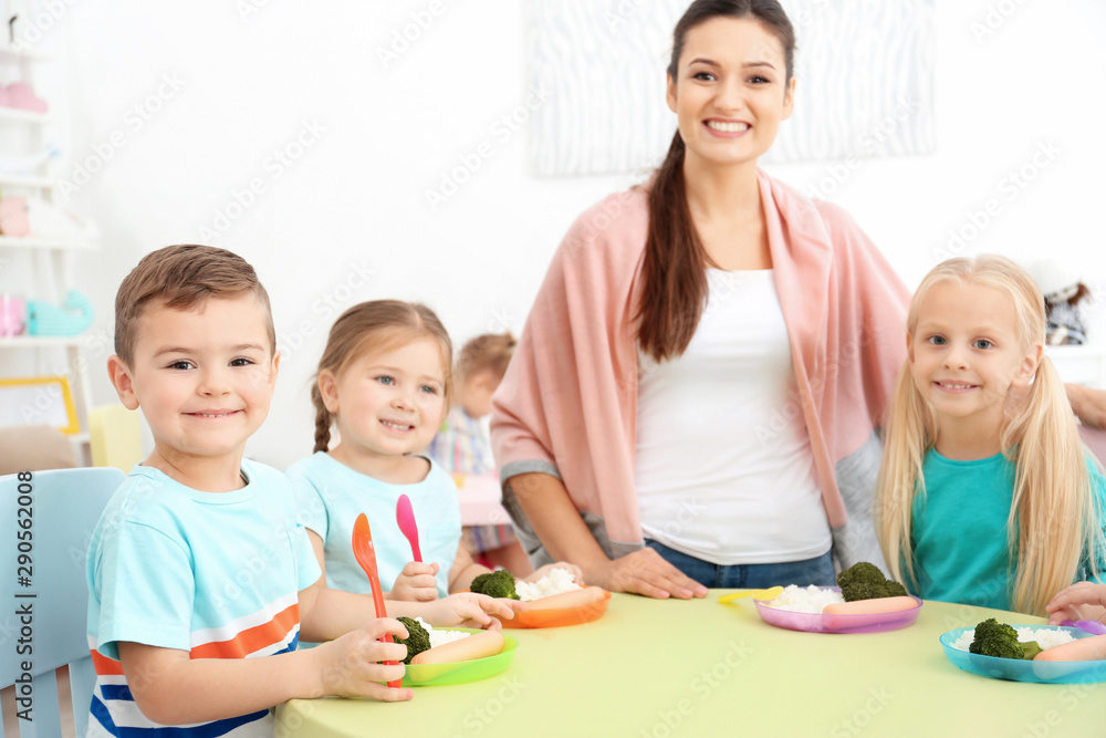 Cute little children eating lunch in kindergarten Cute little children eating lunch in kindergarten