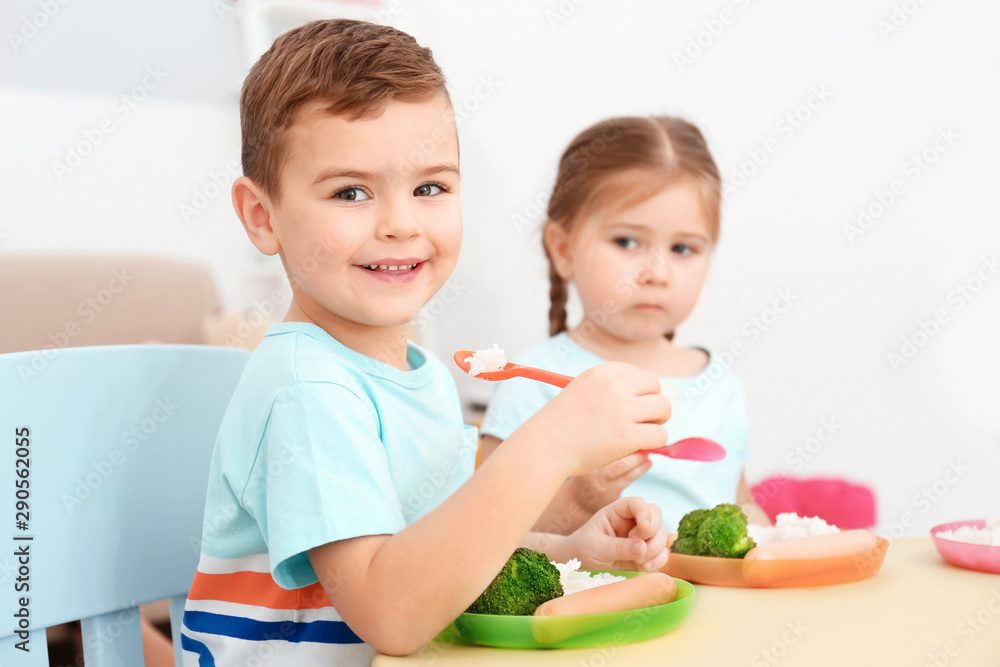 Cute little children eating lunch in kindergarten Cute little children eating lunch in kindergarten