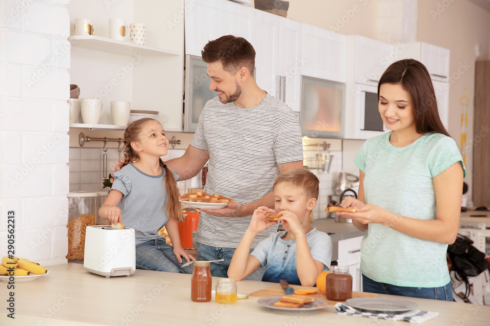 Happy family having breakfast with toasts in kitchen Happy family having breakfast with toasts in kitchen