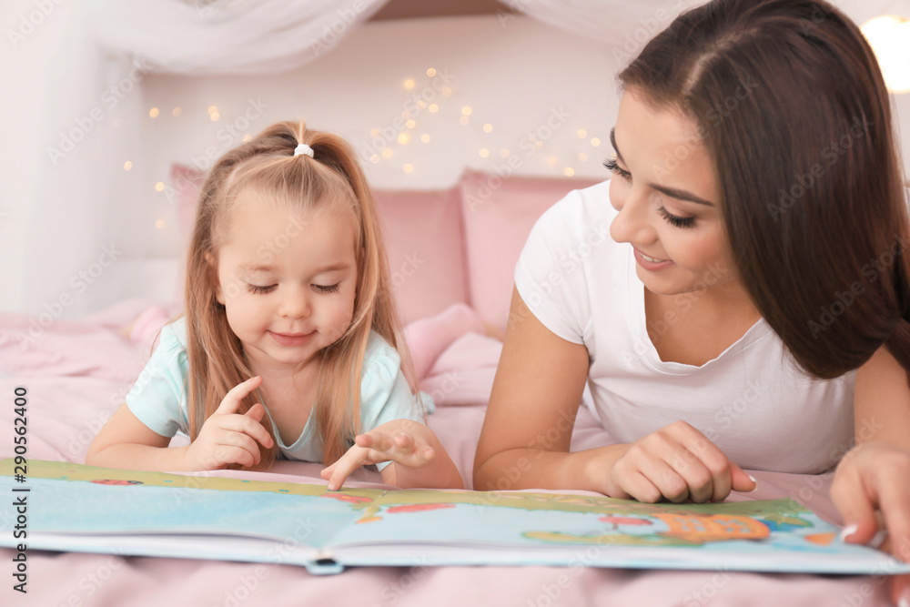 Mother and her little daughter reading bedtime story at home Mother and her little daughter reading bedtime story at home