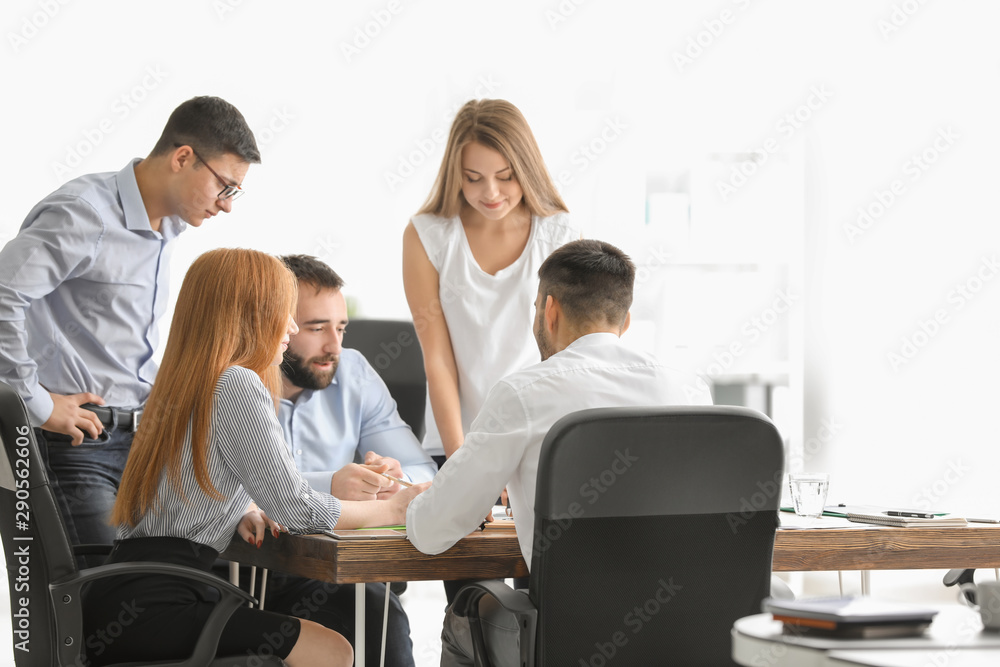 Young marketing expert with team at business meeting