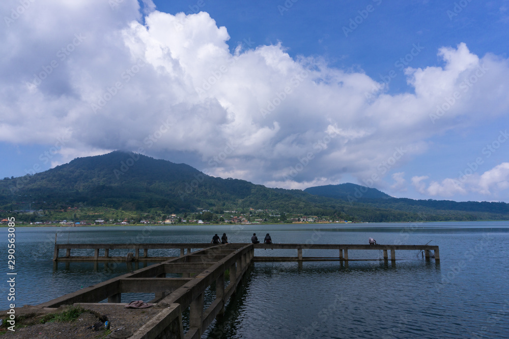 local residents fishing at Buyan Lake while looking at the beauty and coolness of the lake buyan, bali in the morning