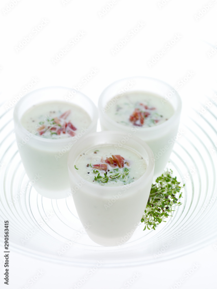 Bacon and Cress soups shots on blowing white background Bacon and Cress soups shots on blowing white background