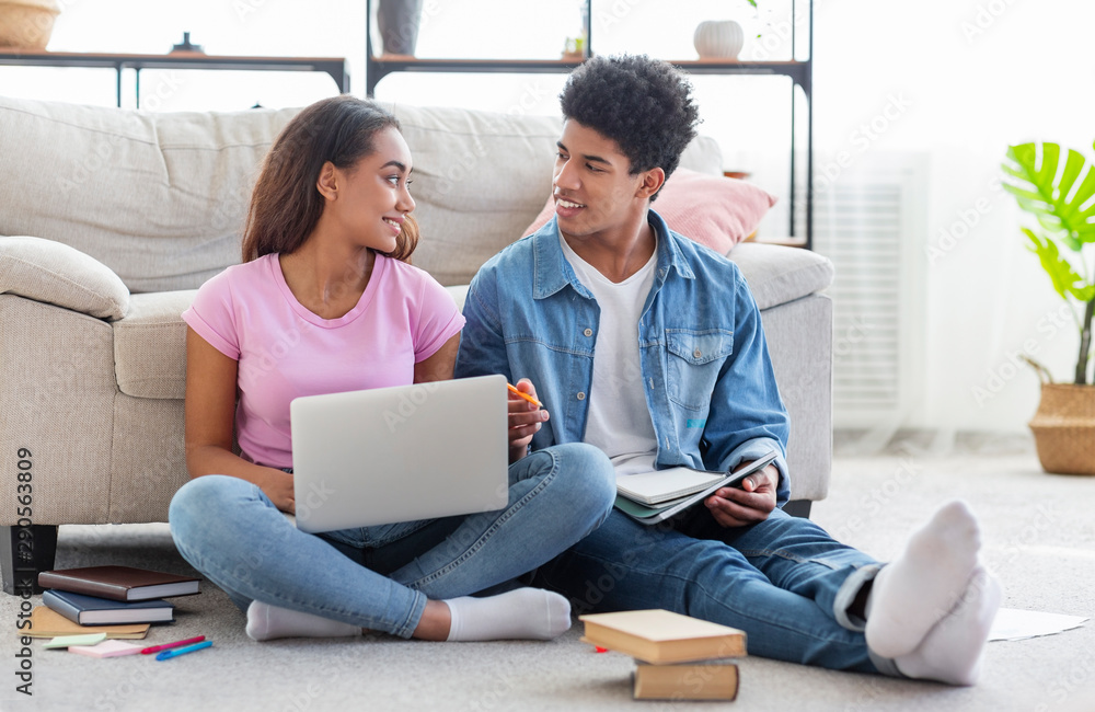 Young black students working on laptop together at home Young black students working on laptop together at home