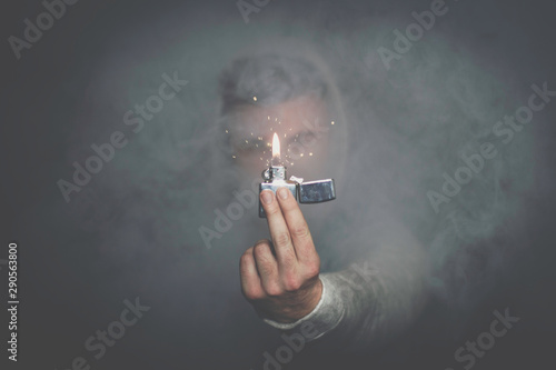 A man who flicked a bic through a haze. photo