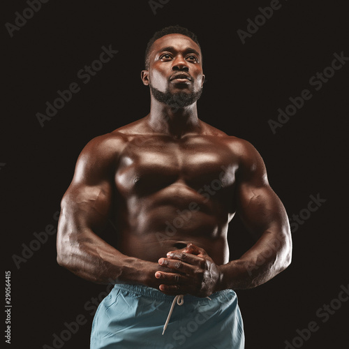 Portrait of handsome muscular sportsman demonstrating his body