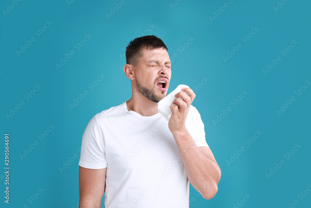 Man suffering from allergy on blue background Man suffering from allergy on blue background