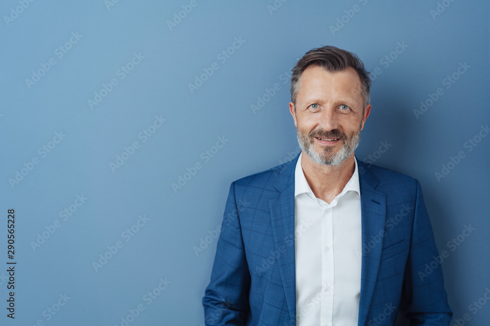 Smart friendly businessman smiling at the camera Smart friendly businessman smiling at the camera