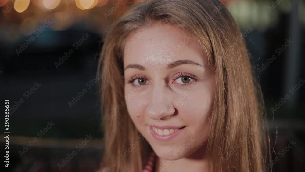 Beautiful young girl on a bench in the evening in a park. Beautiful young girl on a bench in the evening in a park.
