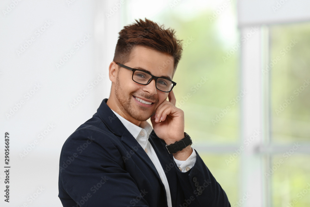 Portrait of handsome young man in elegant suit with glasses indoors Portrait of handsome young man in elegant suit with glasses indoors