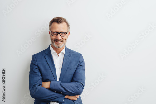 Fotografie Friendly businessman posing with folded arms