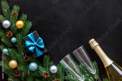 Champagne for New Year's Eve on black background top view frame copy space