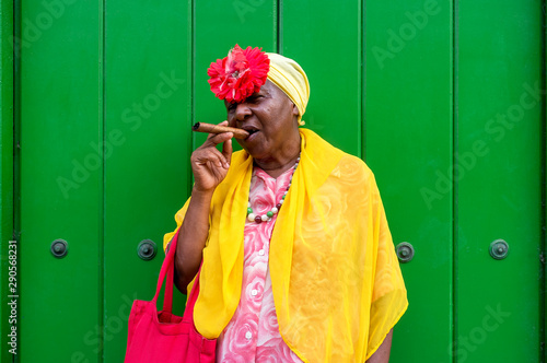 Old Cuban lady smoking a large cigar in La Havana, Cuba