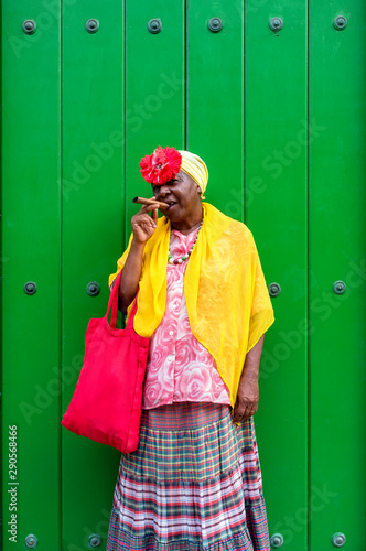 Old Cuban lady smoking a large cigar in La Havana, Cuba