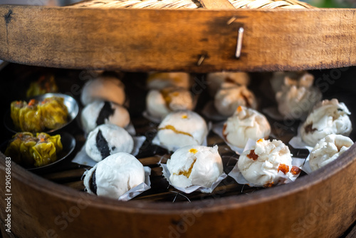 Chinese dumplings being steamed on the traditional bamboo pan