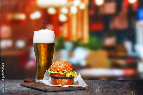 Frosty glass of light beer with hamburger