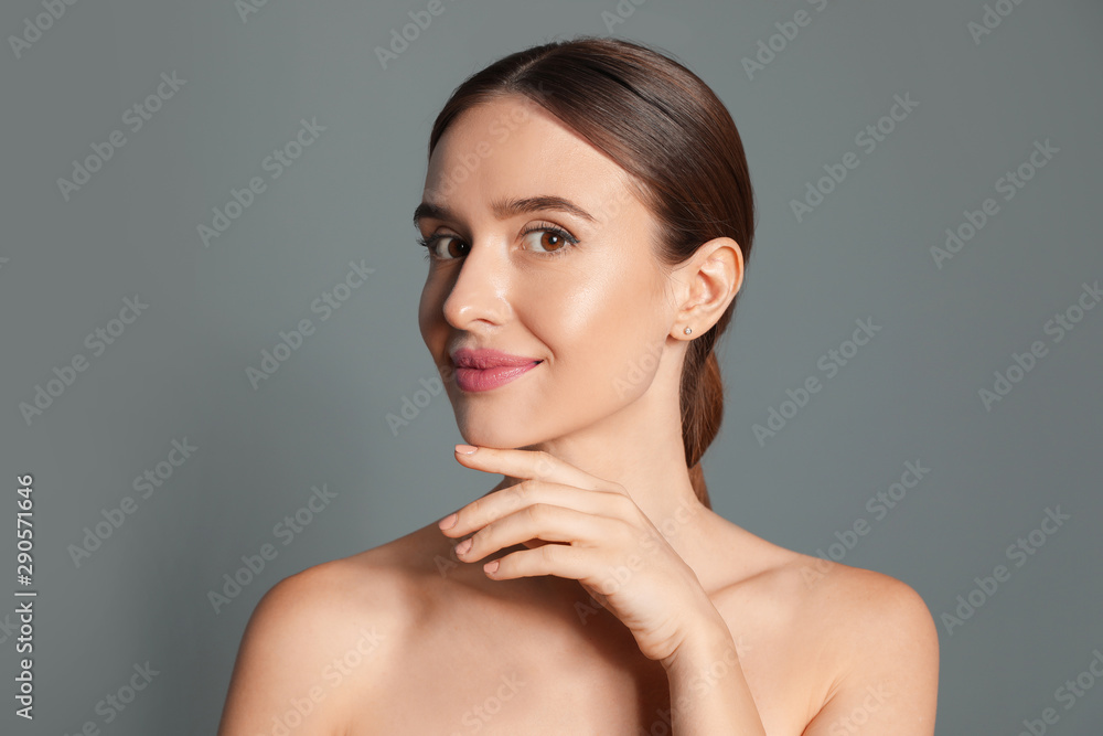 Beautiful woman with perfect smooth skin on grey background Beautiful woman with perfect smooth skin on grey background