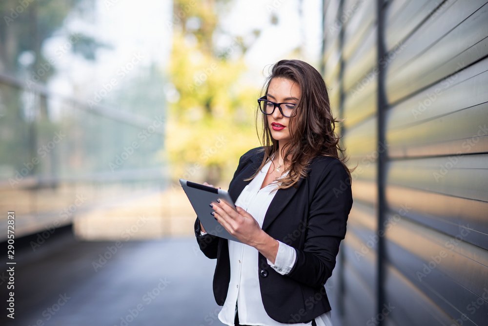 Woman with tablet on hands outside the office Woman with tablet on hands outside the office