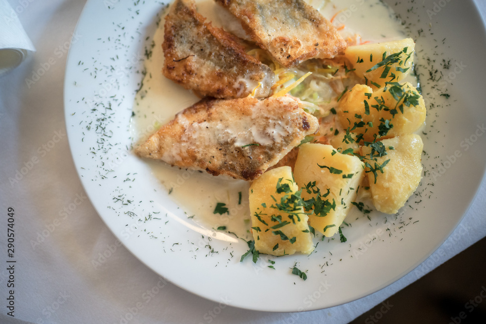 Cross fish with potatoes on plate Cross fish with potatoes on plate