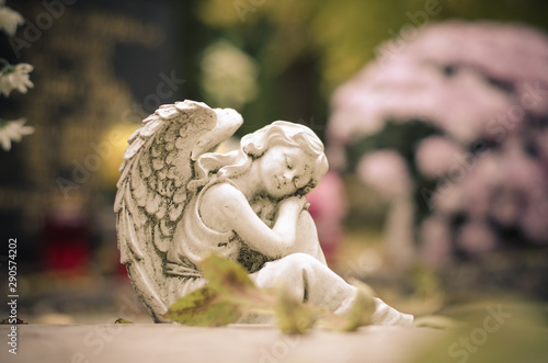 All Saints Day in the cemetery and white angel statue