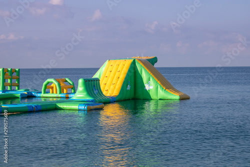 Inflatable trampolines on an early sunny summer morning photo