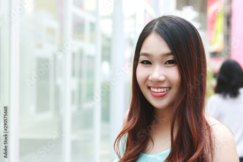 Free Download Beautiful Asian woman smiling with outdoor scene. - GFXLoad