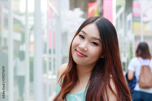 Free Download Beautiful Asian woman smiling with outdoor scene. - GFXLoad
