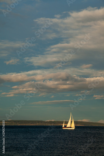 A small Sailboat on the water at sunset near Port Townsend, Washington, USA