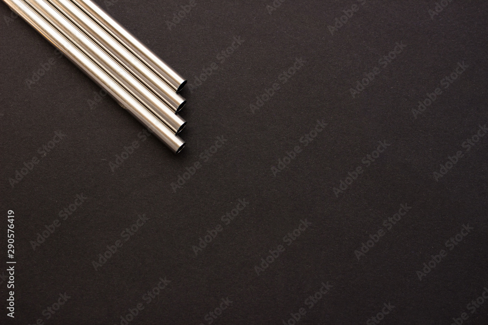 Metal straws on black background. Zero waste. Flat lay Metal straws on black background. Zero waste. Flat lay