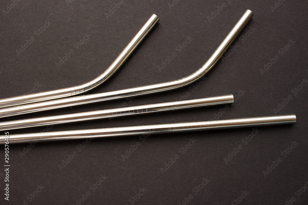 Metal straws on black background. Zero waste. Flat lay Metal straws on black background. Zero waste. Flat lay
