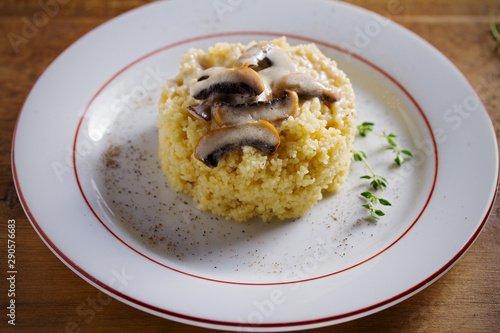 Couscous with mushrooms in cream sauce. Horizontal image