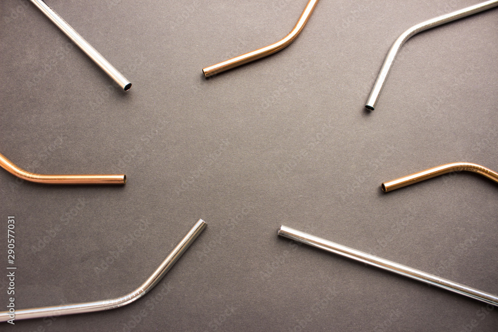 Metal straws on black background. Zero waste. Flat lay Metal straws on black background. Zero waste. Flat lay