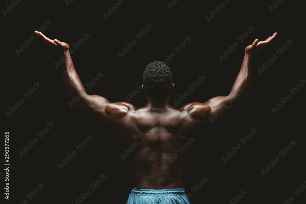 Back view of black bodybuilder raising his hands up Stock Photo | Adobe ...