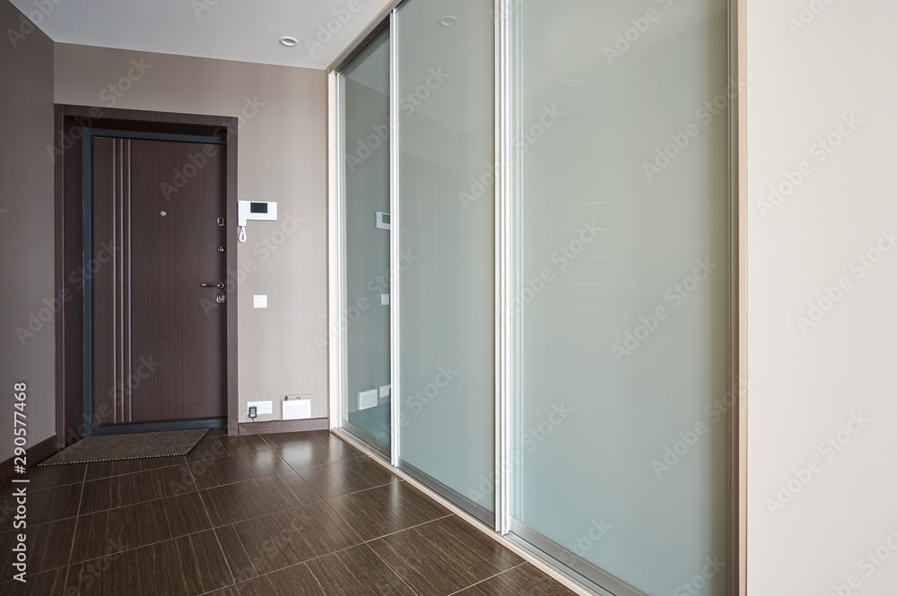 entrance hall with large wardrobe with glass doors
